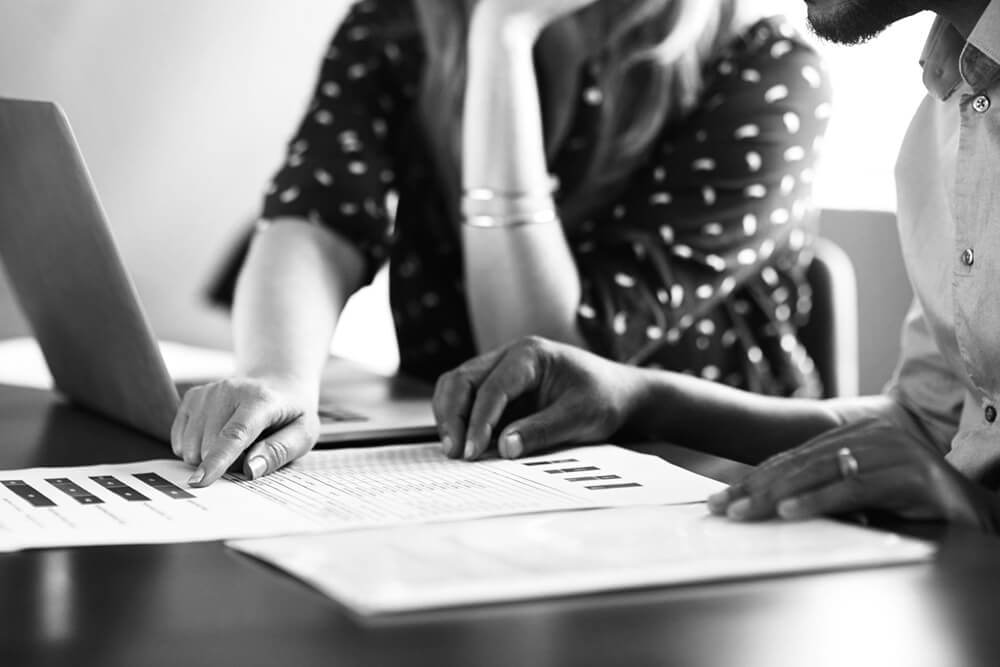 Two people reviewing paperwork together